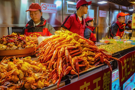 Beijing, China - 25 February 2017: Unacquainted chinese Chef Cooking and Selling local cuisine on wangfujing Walking street in beijing city, China travelのeditorial素材