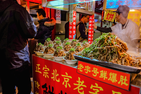 Beijing, China - 25 February 2017 : Unacquainted chinese Chef Cooking and Selling local cuisine on wangfujing Walking street in beijing city, China travelのeditorial素材