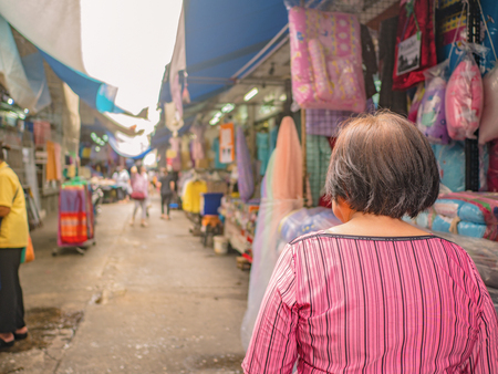 Back of Senior asian women walking and shopping on "Phahurat " Road the Old marketplace in Bangkok City capital of thailandのeditorial素材