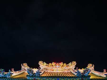Roof of Chinese Temple under the night sky in bangkok City Thailandの写真素材