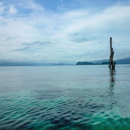 Retro and Local Wood Stick water level Meter on Beautiful idyllic ocean near Koh Wai island Trat Thailand,Thailand Holiday conceptの写真素材
