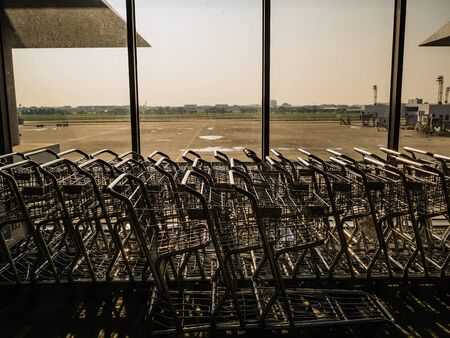 Luggage Cart beside the window in don muang internation airport bangkok City Thailandの写真素材