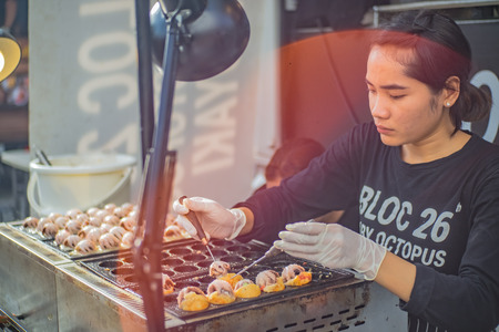 Bangkok,Thailand - 9 July 2017:Unacquainted Chef Cooking Giant octopus Takoyaki on Tako stove.Takoyaki The Famous Japan Street Foodのeditorial素材