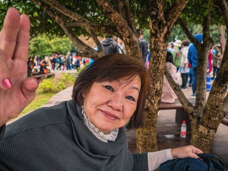 Portrait Senior asian women Wearing the hat on Zhangjiajie National Forest Park in Wulingyuan District Zhangjiajie City China in the Foggy dayの写真素材