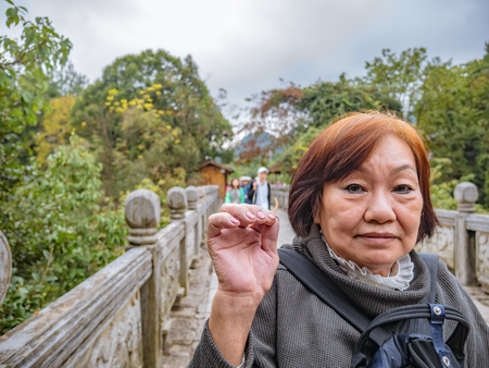 Portrait Senior asian women on Zhangjiajie National Forest Park in Wulingyuan District Zhangjiajie City Chinaのeditorial素材