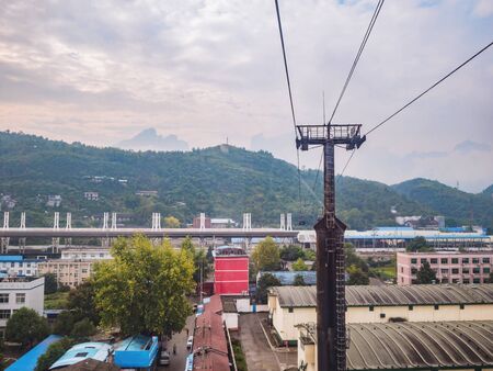 Beautiful zhangjiajie Cityscape and mountain view from cable car to tianmen mountain in the morning.Downtown Urban building scene of zhangjiajie city hunan chinaのeditorial素材