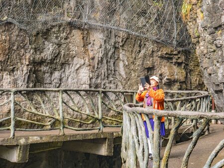 zhangjiajie/China - 15 october 2018: Unacquainted Tourists with Guigu moat on tianmen mountain at Zhangjiajie city china.Tianmen mountain the travel destination of Hunan zhangjiajie city Chinaのeditorial素材