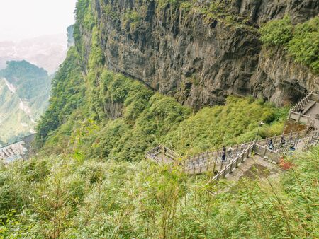 zhangjiajie/China-15 october 2018:Unacquainted Tourists climb up and down to heaven gate cave on heaven gate  stairs 999 step on tianmen mountain national park at Zhangjiajie city china.の写真素材