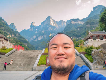 selfie photo of backpacker with beautiful view on viewpoint on the bottom of tianmen mountain national park at Zhangjiajie city china.travel destination of Hunan zhangjiajie city Chinaのeditorial素材