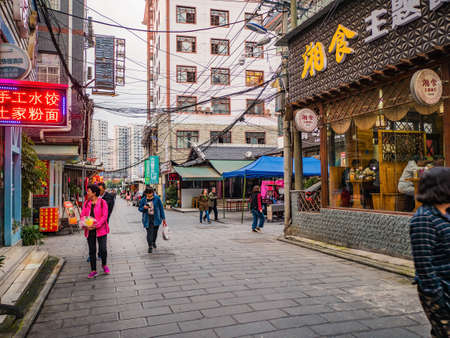 zhangjiajie/China-15 october 2018:Unacquainted People walking in Downtown district at Zhangjiajie city china.Urban downtown building of zhangjiajie city hunan china