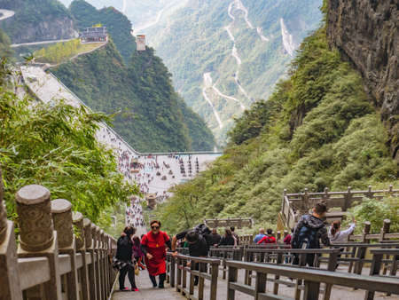 zhangjiajie/China-15 october 2018:Unacquainted Tourists climb up and down to heaven gate cave on heaven gate  stairs 999 step on tianmen mountain national park at Zhangjiajie city china.のeditorial素材