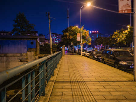 zhangjiajie/China - 14 October 2018:Beautiful sidewalk beside the road and nature of Zhangjiajie city in the night.zhangjiajie City china travelのeditorial素材