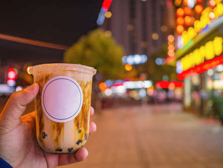 Bubble milk tea with Dark sugar mix in the milk tea in the Tourist hand at zhangjiajie city Chinaのeditorial素材