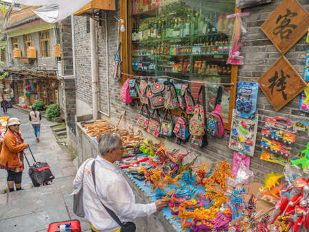 fenghuang,Hunan/China-16 October 2018:Tourist with traditional shop in alley district of Fenghuang ancient town.phoenix ancient town or Fenghuang County is a county of Hunan Province, Chinaのeditorial素材