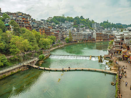 Fenghuang,Hunan/China-16 October 2018:Wooden bridge and Beautiful scenery old Building of Fenghuang ancient town.phoenix ancient town or Fenghuang County is a county of Hunan Province, Chinaのeditorial素材