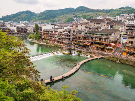 Fenghuang,Hunan/China-16 October 2018:Wooden bridge and Beautiful scenery old Building of Fenghuang ancient town.phoenix ancient town or Fenghuang County is a county of Hunan Province, Chinaのeditorial素材