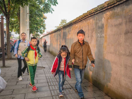 zhangjiajie/China - 16 October 2018:Unacquainted People walking near School district of Zhangjiajie city in the morning.zhangjiajie City china travelのeditorial素材