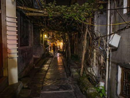 fenghuang,Hunan/China-16 October 2018:Tourist walking in alley building district of Fenghuang ancient town.phoenix ancient town or Fenghuang County is a county of Hunan Province, Chinaのeditorial素材