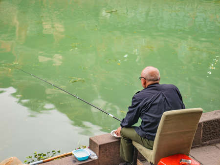 fenghuang,Hunan/China-16 October 2018:Unacquainted Chinese local people fishing in the river of fenghuang old town .phoenix ancient town or Fenghuang County is a county of Hunan Province, Chinaのeditorial素材