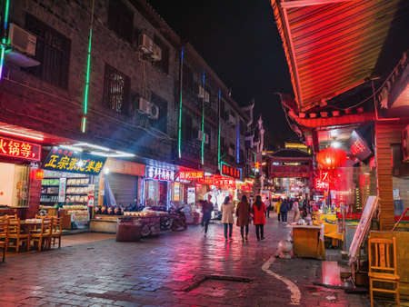 fenghuang,Hunan/China-16 October 2018:Tourist walking in the evening of  fenghuang old town.phoenix ancient town or Fenghuang County is a county of Hunan Province, Chinaのeditorial素材