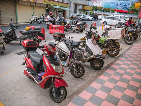 Shantou/china-30 march 2018:Chinese electric motorcycle parking downtown district at shantou city at china.electric motorcycle is the most famous automobile in chinaのeditorial素材