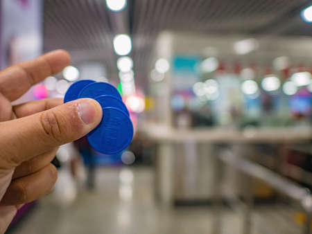 Changsha/China-17 October 2018:Tourist Hand hold Single journey Metro Coin or Ticket in Changsha South Train station  hunan province China.のeditorial素材