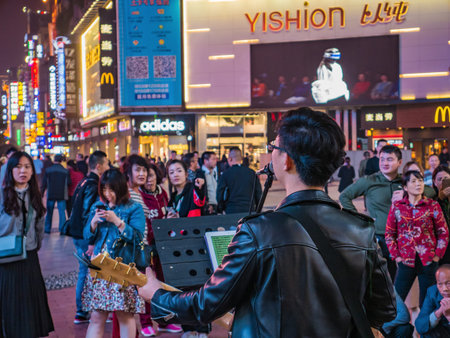 Changsha/China-17 October 2018:Unacquainted street performers singing at huangxing walking street in Changsha city China.changsha is the capital and most populous city of Hunan province in chinaのeditorial素材