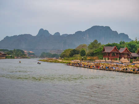 Vangvieng/lao-4 Dec 2017:Beautiful view of nam song river with riverside restaurant and the mountain at Vangvieng city Lao.Vangvieng City The famous holiday destination town in Lao.のeditorial素材