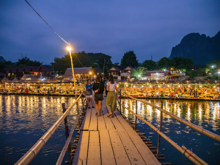 Vangvieng/lao-4 Dec 2017:Unacquainted People on the wooden bridge with beautiful view of Nam Song River in vangvieng Lao.Vangvieng City The famous holiday destination town in Lao.のeditorial素材
