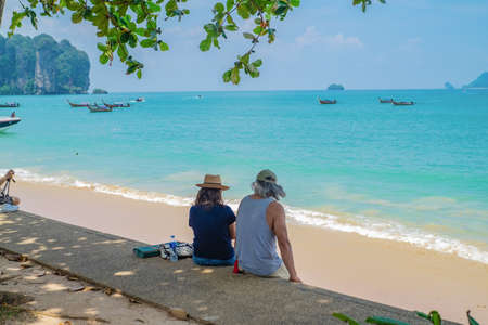Unacquainted Woman sitting beside Ao nang beach with beautiful seascape and Endless horizon in krabi city Thailand.Krabi - in southern Thailand is one of the most relaxing places on the planetのeditorial素材