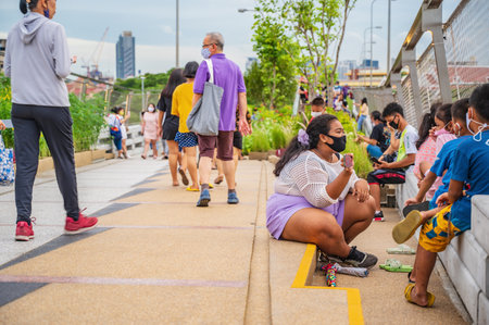 Bangkok/Thailand- 04/07/2020-Unacquainted people on chao phraya skypark.The elevated Chao Phraya Skypark spans 280 meters over the Chao Phraya River.Thonburi Bangkok Thailand.のeditorial素材
