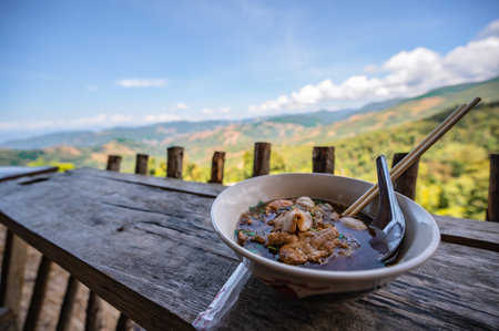 Close up thai noodle with beautiful landscape view of doi skad at nan thailand.Nan is a rural province in northern Thailand bordering Laosの写真素材