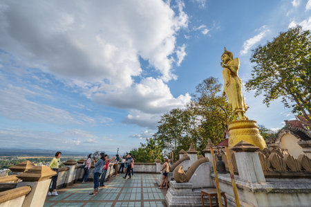 Nan.thailand-19.12.2020:Unacquainted People with golden buddha statue on the mountain at Wat Phrathat Khao Noi at nan thailand.のeditorial素材