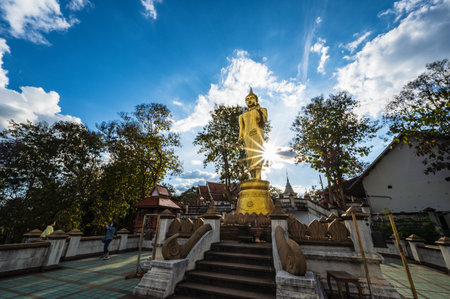 Nan.thailand-19.12.2020:Unacquainted People with golden buddha statue on the mountain at Wat Phrathat Khao Noi at nan thailand.のeditorial素材