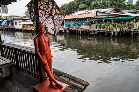 Bangkok.Thailand 16.10.2022.Fat old man Art statue at khlong bang luang floating market is a quaint market just a short distance outside the city center of Bangkok.Artist House at Khlong Bang Luangのeditorial素材