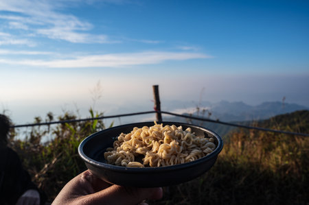 Instant noodle with Beautiful mountain range on khao san nok wua kanchanaburi.Khao San Nok Wua is the highest mountain in Khao Laem National Park. It is 1767 meters above sea level.の写真素材