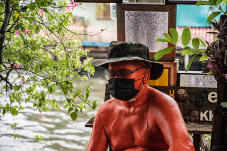 Bangkok.Thailand 16.10.2022.Fat old man Art statue at khlong bang luang floating market is a quaint market just a short distance outside the city center of Bangkok.Artist House at Khlong Bang Luangのeditorial素材