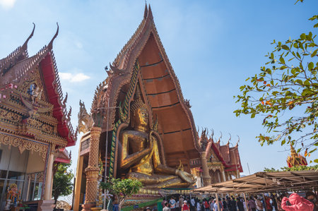 kanchanaburi.thailand-16.1.2022:unacquainted people at Wat Tham Suea (Tiger Cave Temple) kanchanaburi.An 18-meter-tall Buddha built in 1973 is the focus of this well-known temple on a hilltop.のeditorial素材