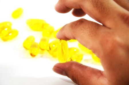 Capsules of fish oil on hand