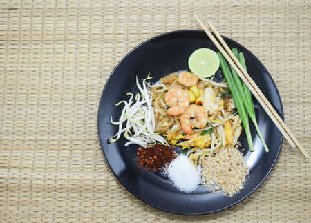 Padthai Fried noodle with shrimp on mat background ,as famous food of Thailandの写真素材