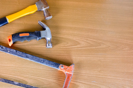 close up ,Set of tools over a wood panel with space for text,set of construction tools,hammer , nail ,screwdriver,saw, copy  space backgroundの写真素材
