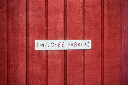 Employee Parking Sign on Red Wooden Wall