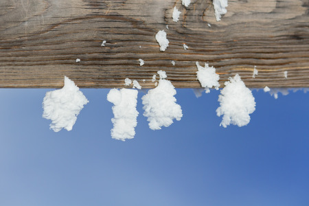 Frost made from steaming water hanging on wooden fence like snow ornament.の写真素材
