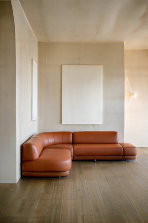 Modern living room interior with brown leather sofa and blank poster on wallの素材