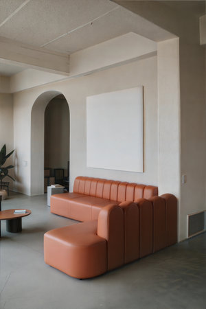 Interior of a hotel lobby with orange sofa and blank picture frameの素材