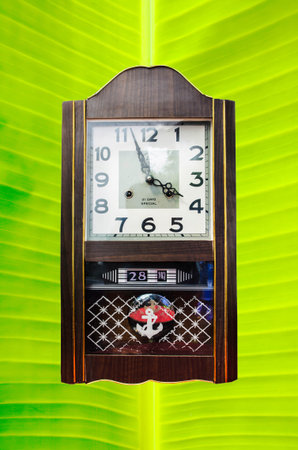 Vintage clock on banana leaf