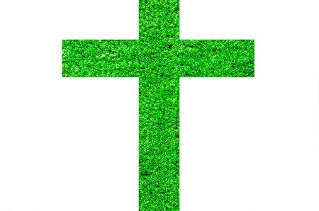 The cross is made of artificial grass on a white background.の写真素材