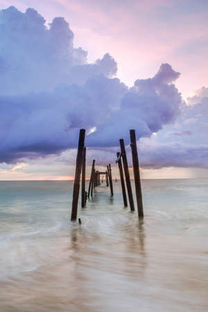 old miner bridge in the kaopilay beach at sunset time slow shutterの写真素材