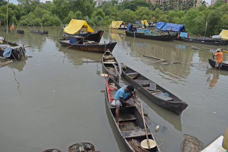 Unidentified Vietnamese fisherman rowing a boat on the Mekong river.の写真素材