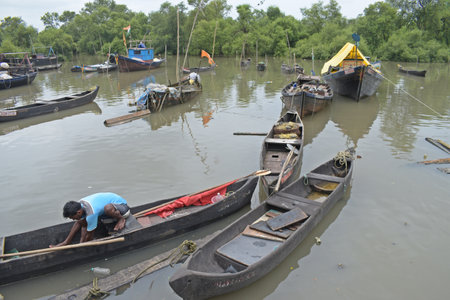 Unidentified people are rowing boats in the river.の写真素材